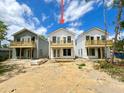 New construction home showing rear exterior elevation with wood porches on the second story and sliding glass doors at 2033 Echo Ave, North Charleston, SC 29405