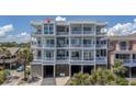Multi-story condo building with balconies and covered parking spaces below at 216 W Arctic Ave # 9, Folly Beach, SC 29439