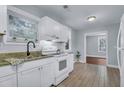 Bright kitchen with white cabinets, granite countertops, stainless steel appliances, and tile flooring at 2350 Kent Ave, North Charleston, SC 29405