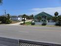 Street view of the neighborhood, featuring well-maintained homes and lush landscaping at 2401 Palmetto Blvd, Edisto Island, SC 29438
