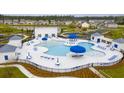 Aerial view of a community pool with blue umbrellas and plenty of lounge chairs at 261 Celestial Blvd, Summerville, SC 29486