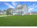 Attractive two-story home with a large, lush green lawn and inviting double porches at 300 Saxony Loop, Summerville, SC 29486