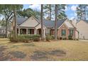 Lovely brick home featuring a cozy front porch and manicured landscaping at 315 Clubview Rd, Summerville, SC 29485