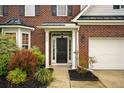 Close-up of the front door with nice landscaping at 317 Sabal Palmetto Ct, Moncks Corner, SC 29461