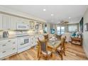 Inviting dining area with seating for four and waterfront views at 3701 Docksite Rd # 220, Edisto Island, SC 29438