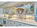 This kitchen features white cabinetry and stainless steel appliances at 3701 Docksite Rd # 220, Edisto Island, SC 29438