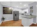 Bright kitchen featuring white cabinets, stainless steel appliances, granite countertops, and hardwood floors at 4003 Radcliffe Place Dr # B6, Charleston, SC 29414