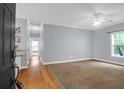 Spacious living room with hardwood flooring at entry and carpet, ceiling fan, and natural light at 4003 Radcliffe Place Dr # B6, Charleston, SC 29414
