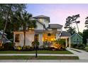 Beautiful home with a manicured lawn, covered porch, palm trees, and a side carport and driveway at 4009 E Amy Ln, Johns Island, SC 29455