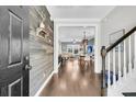 Stylish entryway with wood-paneled accent wall, hardwood floors, and staircase leading to the upper level at 4235 Scharite St, Charleston, SC 29414