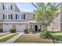 Charming townhome with a two-car garage, neat landscaping, and a welcoming front porch at 4235 Scharite St, Charleston, SC 29414