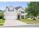 Charming two-story home with a well-manicured lawn, white garage door and black shutters at 428 Cabrill Dr, Charleston, SC 29414