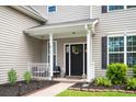 Charming front porch with black door, American flag pillow and landscaped garden at 428 Cabrill Dr, Charleston, SC 29414