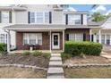 Charming brick and siding townhome featuring a cozy front porch and manicured landscaping at 432 Doane Way, Wando, SC 29492