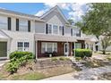 Charming brick and siding townhome featuring a cozy front porch and manicured landscaping at 432 Doane Way, Wando, SC 29492