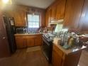 Cozy kitchen with wood cabinets, laminate countertops, and a stainless-steel appliance suite at 4462 Hardwood St, Ladson, SC 29456
