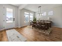 Bright dining area featuring hardwood floors, modern lighting, and large windows offering ample natural light at 459 White Magnolia St, Moncks Corner, SC 29461