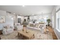 Spacious living room with hardwood floors, natural lighting, and an open layout flowing into the kitchen at 459 White Magnolia St, Moncks Corner, SC 29461