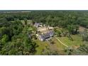 An aerial view of the estate with a pool, riding stables, and lush greenery at 4855 Retriever Rd, Wadmalaw Island, SC 29487