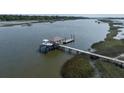 A private boat lift offers easy access to waterfront adventures from the home's dock at 4855 Retriever Rd, Wadmalaw Island, SC 29487