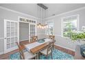 Light-filled dining room featuring stylish lighting and neutral wall paint at 493 Nelliefield Trl, Wando, SC 29492