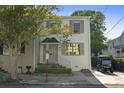 Inviting two-story home featuring neat landscaping, a paved walkway, and a designated parking spot at 5 Smith St, Charleston, SC 29401