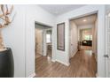 Bright hallway with wood-look floors, neutral walls, and doorways leading to various rooms at 524 Richfield Way, Summerville, SC 29486