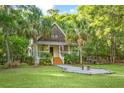 Charming two-story home with a cozy front porch, decorative shutters and a well-manicured lawn at 5348 Mccullough Dam Rd, Wadmalaw Island, SC 29487