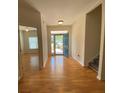 Bright foyer boasts gleaming hardwood floors, natural light, and a view of the staircase at 7517 Whispering Oak Dr, Hanahan, SC 29410