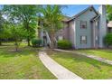 Charming two-story townhouse with gray and brown siding, steps, and a well-maintained lawn at 7921 Cricket Ct # 305 E, North Charleston, SC 29418