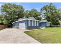 A blue single story home featuring an attached garage and long concrete driveway at 809 O'Sullivan Dr, Mount Pleasant, SC 29464