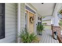 Close-up of a charming front porch featuring a decorative wreath and potted plants at 9524 Markley Blvd, Summerville, SC 29485