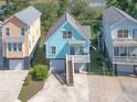Charming coastal home with a covered porch, showcasing its elevated design, outdoor appeal and garage at 1022 Hunley Waters Cir, North Charleston, SC 29405