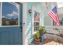 Inviting front porch with plants and an American flag, offering a warm welcome and classic charm at 1022 Hunley Waters Cir, North Charleston, SC 29405