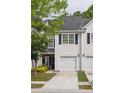 Charming townhouse featuring a one-car garage and tidy landscaping at 1054 Bennington Dr, Charleston, SC 29492