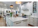 Bright kitchen boasts a marble island, custom cabinets, and stainless steel appliances at 1081 Groves Manor Ct, Mount Pleasant, SC 29464