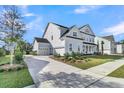 The property boasts a two-car garage and a well-maintained yard on a sunny day at 1095 Saltwater Cir, Johns Island, SC 29455
