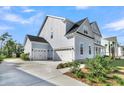 Side exterior shows the home has a two-car garage and plenty of yard space at 1095 Saltwater Cir, Johns Island, SC 29455
