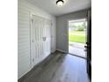Inviting entryway features light gray plank flooring and a shiplap accent wall with a double-door closet at 1102 Hampton Ct, Summerville, SC 29486