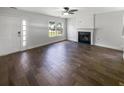 Open-concept living room featuring a fireplace, hardwood floors, and modern lighting at 1128 Peninsula Cove Dr, Charleston, SC 29492