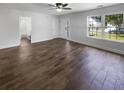 Spacious living room featuring hardwood floors, bright windows and a bathroom entrance at 1128 Peninsula Cove Dr, Charleston, SC 29492