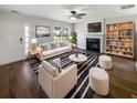 Bright living room featuring neutral furniture, a fireplace, hardwood floors, and a ceiling fan at 1128 Peninsula Cove Dr, Charleston, SC 29492