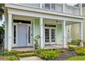 Inviting front porch with a porch swing, well-manicured landscaping, and classic design at 122 Foxglove Ave, Summerville, SC 29483