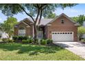 Charming brick home with a well-manicured front yard and mature trees at 1232 Palmetto Peninsula Dr, Mount Pleasant, SC 29464
