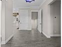 Inviting home hallway showcasing hardwood floors, modern paint colors, and stylish lighting at 1327 Wood Sorrel Dr, Moncks Corner, SC 29461