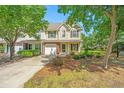 Charming two-story home with a manicured lawn and inviting front entrance, complemented by lush trees at 149 Darcy Ave, Goose Creek, SC 29445