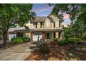 Charming two-story home with a manicured lawn and inviting front entrance, complemented by lush trees at 149 Darcy Ave, Goose Creek, SC 29445