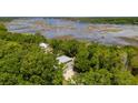 Aerial view of the house showcasing beautiful water and marsh views at 1510 Old Rosebud Trl, Awendaw, SC 29429
