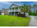 Inviting coastal home featuring a two-story design, lush lawn, and a convenient driveway at 1512 Eagle Landing Blvd, Hanahan, SC 29410