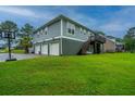 Spacious three-car garage with a basketball hoop and a lush green lawn at 1512 Eagle Landing Blvd, Hanahan, SC 29410
